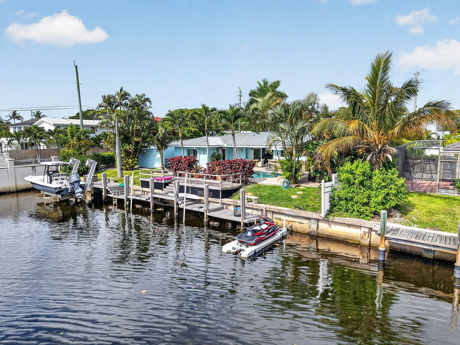 The existing 1965 single-story house and dock infrastructure on the canal